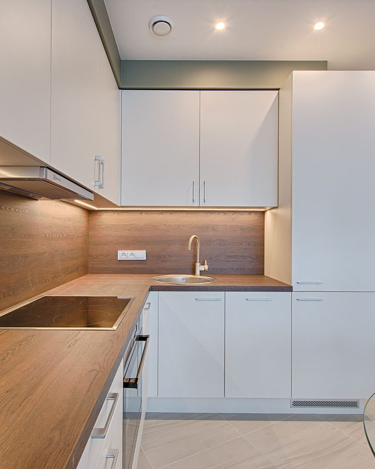 Cuisine rénovée avec plan de travail en bois et façades blanches